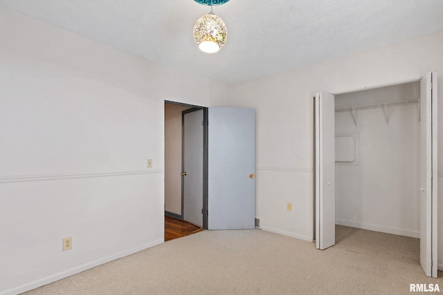 unfurnished bedroom with a closet, carpet floors, and a textured ceiling