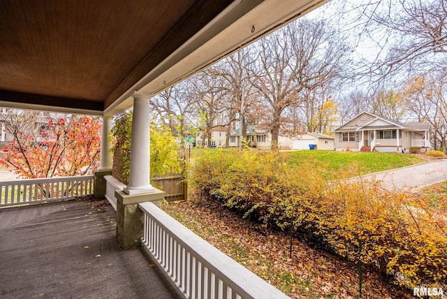 deck featuring a lawn and a porch