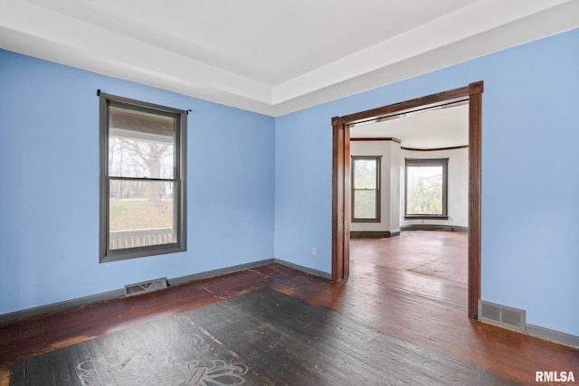 spare room with dark wood-type flooring