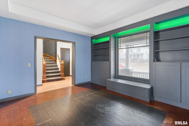 unfurnished living room featuring dark hardwood / wood-style flooring