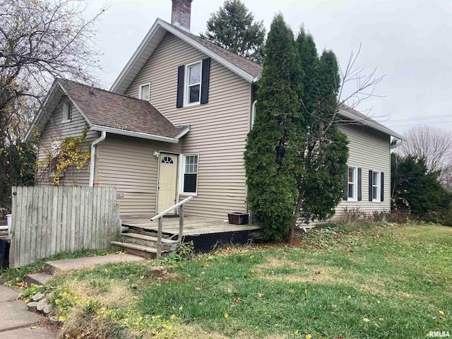 view of front of house with a front yard and a deck