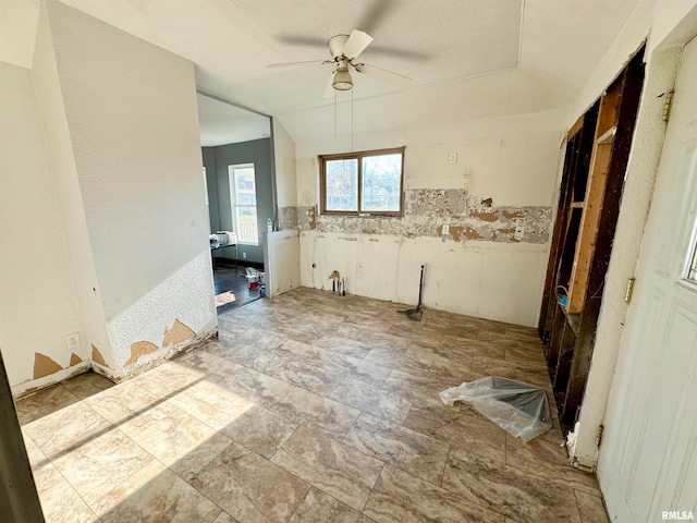 interior space featuring ceiling fan and a textured ceiling