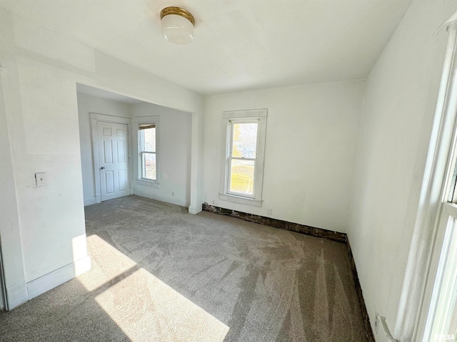 unfurnished room featuring light colored carpet