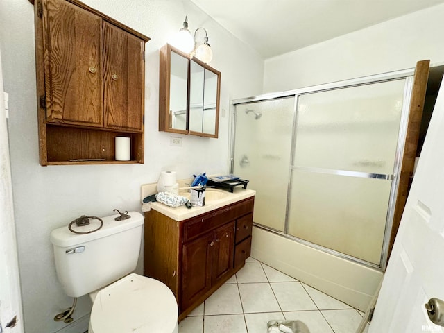 full bathroom with tile patterned flooring, vanity, combined bath / shower with glass door, and toilet