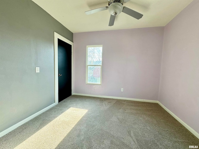 empty room with ceiling fan and carpet floors