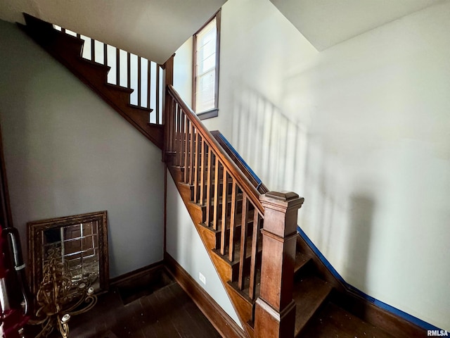 stairway with hardwood / wood-style floors