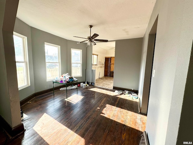 empty room featuring ceiling fan, dark hardwood / wood-style flooring, and a textured ceiling