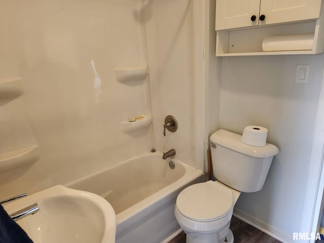 full bathroom with hardwood / wood-style floors, toilet, shower / washtub combination, and sink