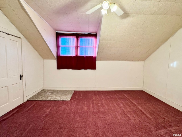 bonus room featuring carpet floors, vaulted ceiling, baseboards, and ceiling fan