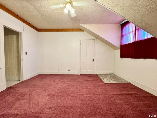 bonus room featuring baseboards, a ceiling fan, and carpet flooring