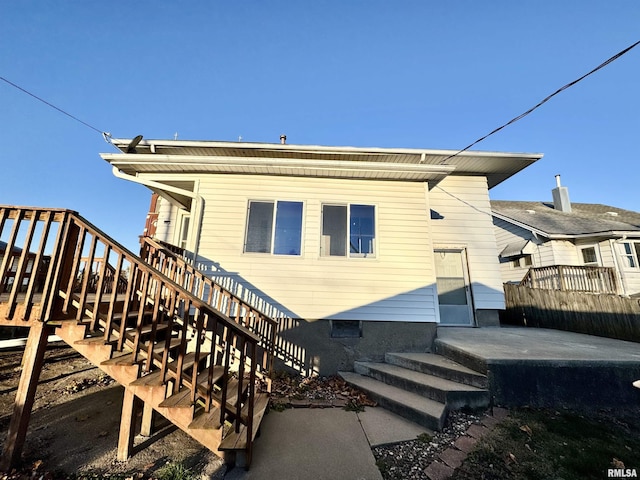 rear view of property with a patio area and stairs