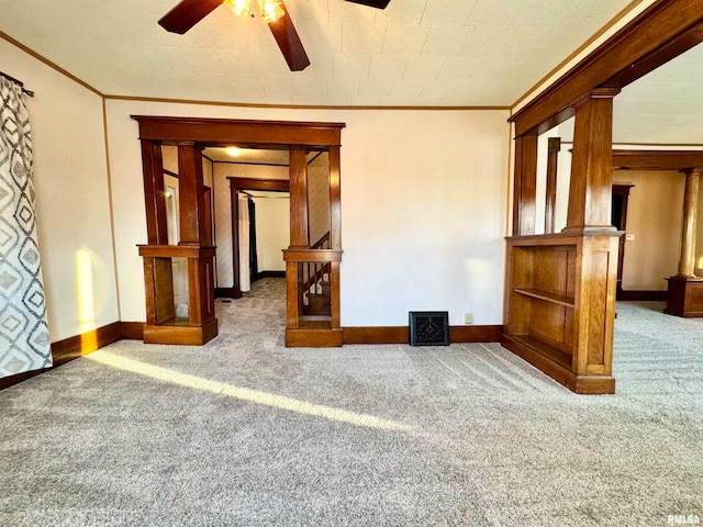 unfurnished room with carpet, crown molding, and baseboards