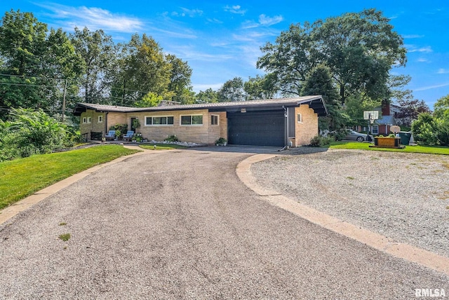 ranch-style home with a front yard and a garage