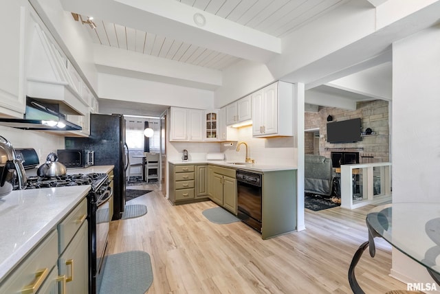 kitchen with sink, black appliances, light hardwood / wood-style flooring, beamed ceiling, and white cabinets