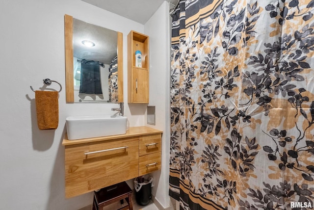 bathroom featuring a shower with curtain and vanity