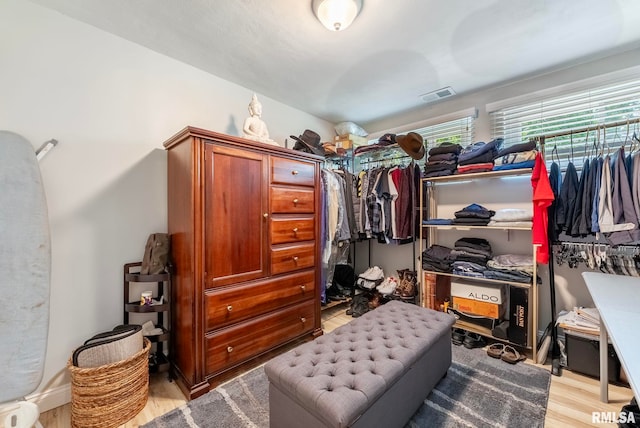 spacious closet with light hardwood / wood-style flooring