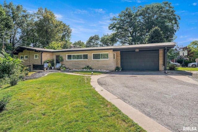 ranch-style house featuring a garage and a front yard