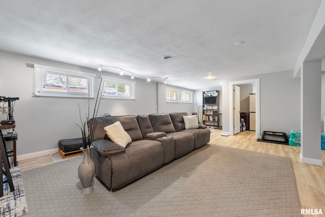 living room featuring light hardwood / wood-style flooring and a wealth of natural light