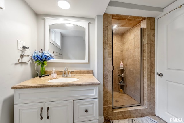 bathroom with vanity and a shower with door