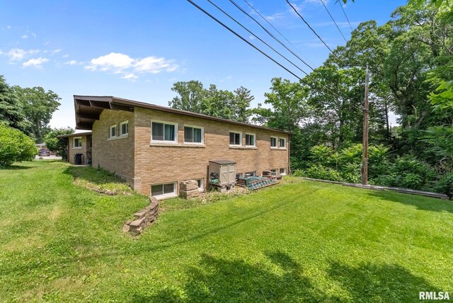 rear view of property featuring a lawn