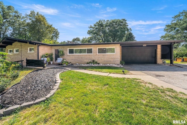 ranch-style home with a garage and a front lawn