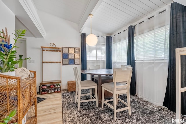 dining area with lofted ceiling with beams, wood-type flooring, and wooden ceiling