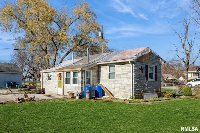 back of property featuring a lawn and a patio area