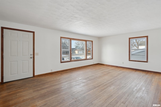 spare room featuring a textured ceiling and hardwood / wood-style flooring