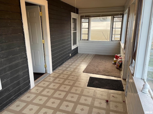 unfurnished sunroom featuring a healthy amount of sunlight