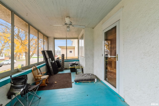 unfurnished sunroom with plenty of natural light and ceiling fan