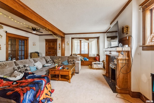 living room featuring ceiling fan, crown molding, light colored carpet, and a textured ceiling