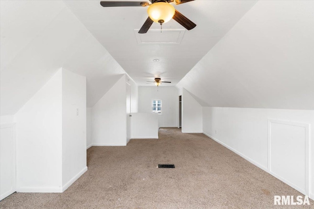 additional living space featuring lofted ceiling and light carpet