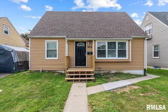 bungalow-style home featuring a front lawn