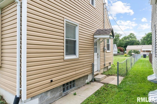 view of side of home with a yard