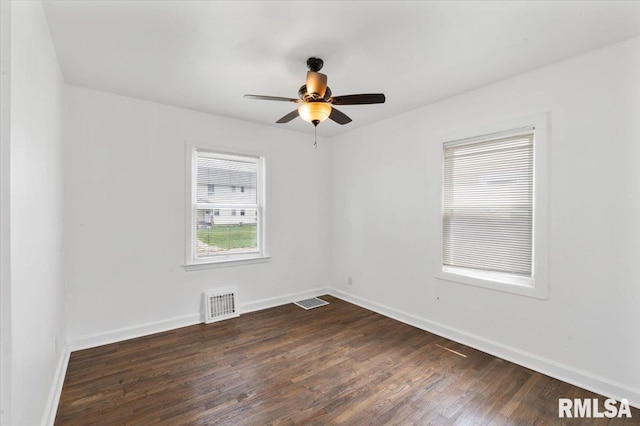 spare room with ceiling fan and dark hardwood / wood-style floors