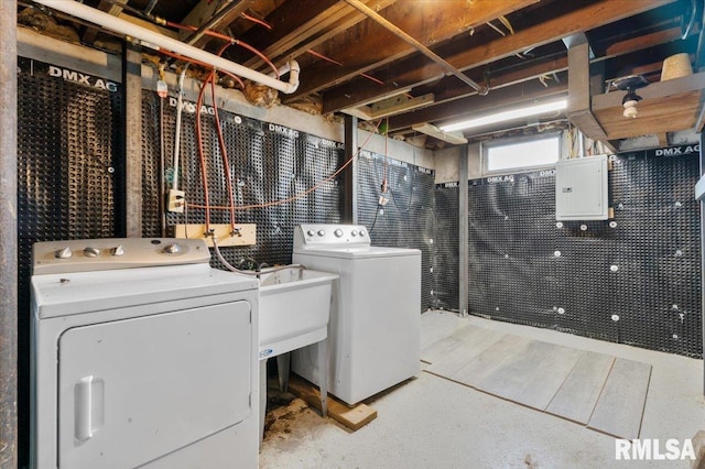 laundry area featuring washing machine and clothes dryer and electric panel