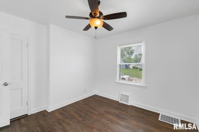 empty room with ceiling fan and dark wood-type flooring