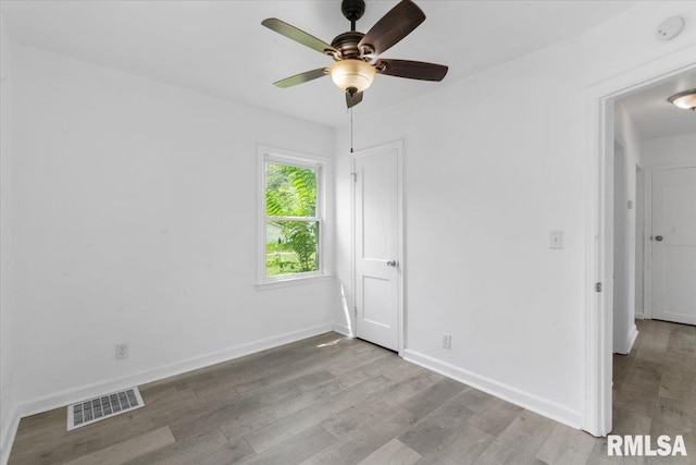 unfurnished room with ceiling fan and light wood-type flooring