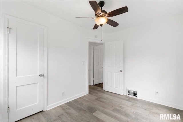 unfurnished bedroom featuring ceiling fan and light wood-type flooring