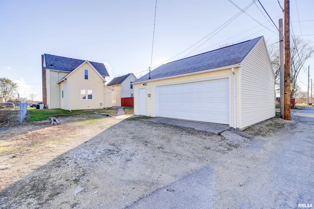 view of front facade with an outbuilding and a garage