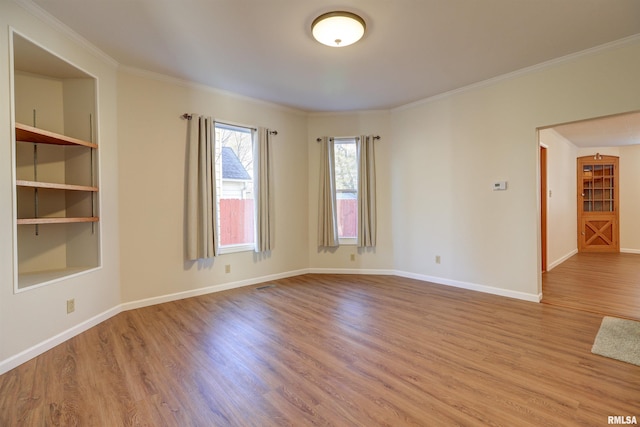 empty room with light hardwood / wood-style flooring and ornamental molding