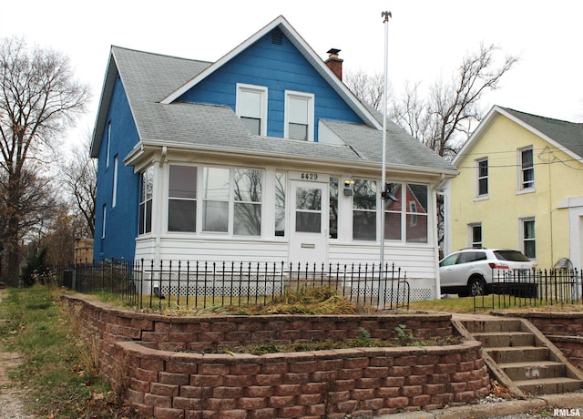 view of front of property with a sunroom