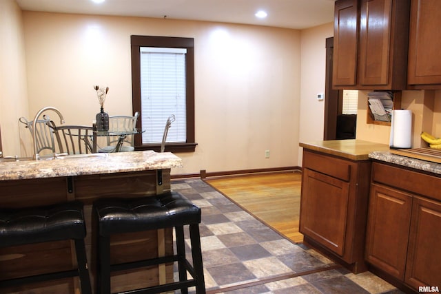 kitchen featuring light stone counters and dark hardwood / wood-style flooring