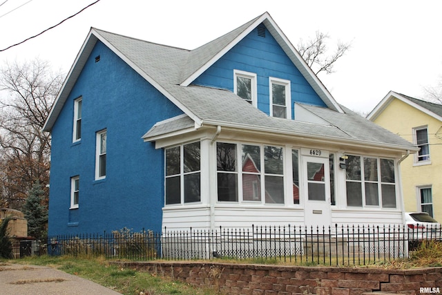 view of home's exterior with a sunroom