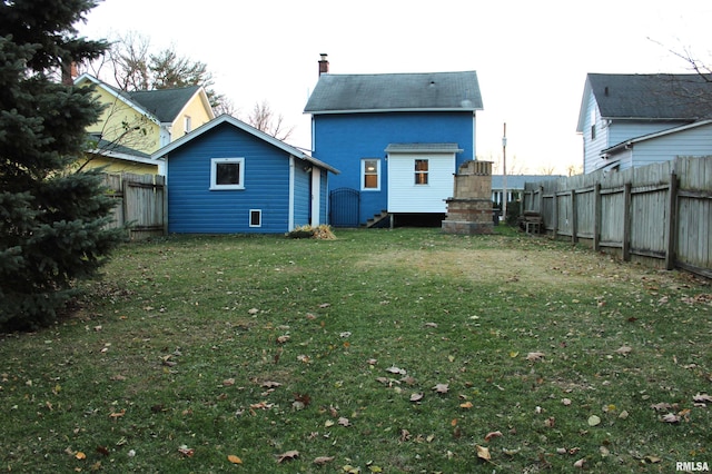 rear view of house with a lawn