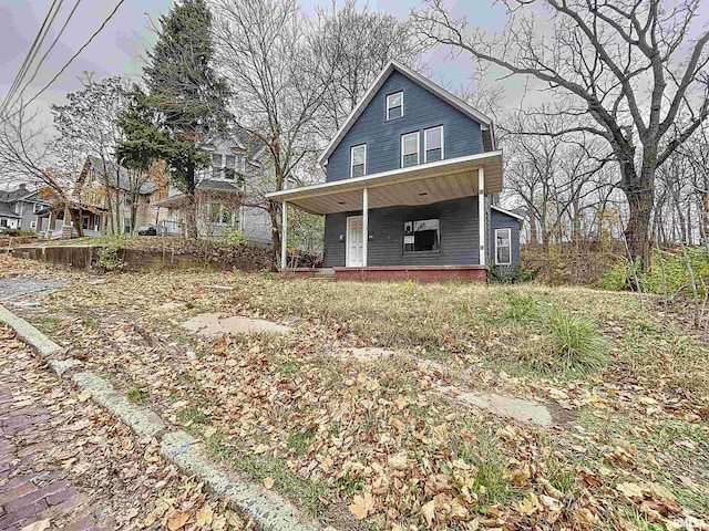 rear view of property featuring a porch