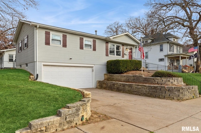 view of front facade with a garage and a front lawn