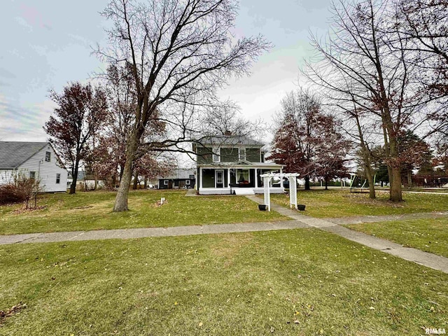 view of front of property with covered porch and a front lawn