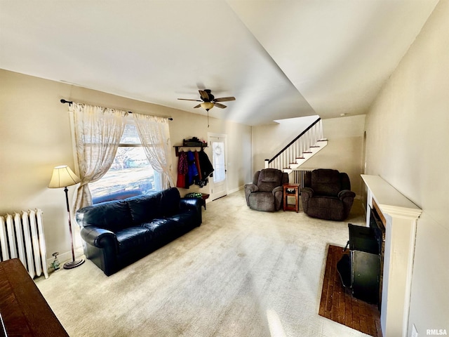 living room featuring carpet, radiator, lofted ceiling, and ceiling fan