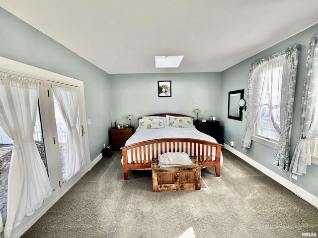 bedroom featuring a skylight and carpet